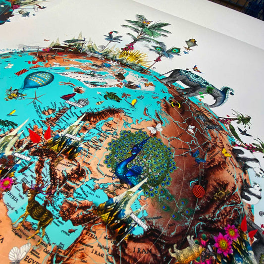 mountain og elephant ocean jordin I blue and brown globe of the world decorated in plants landmarks elephants flowers butterflies and hot air balloons by artist Kristjana Williams