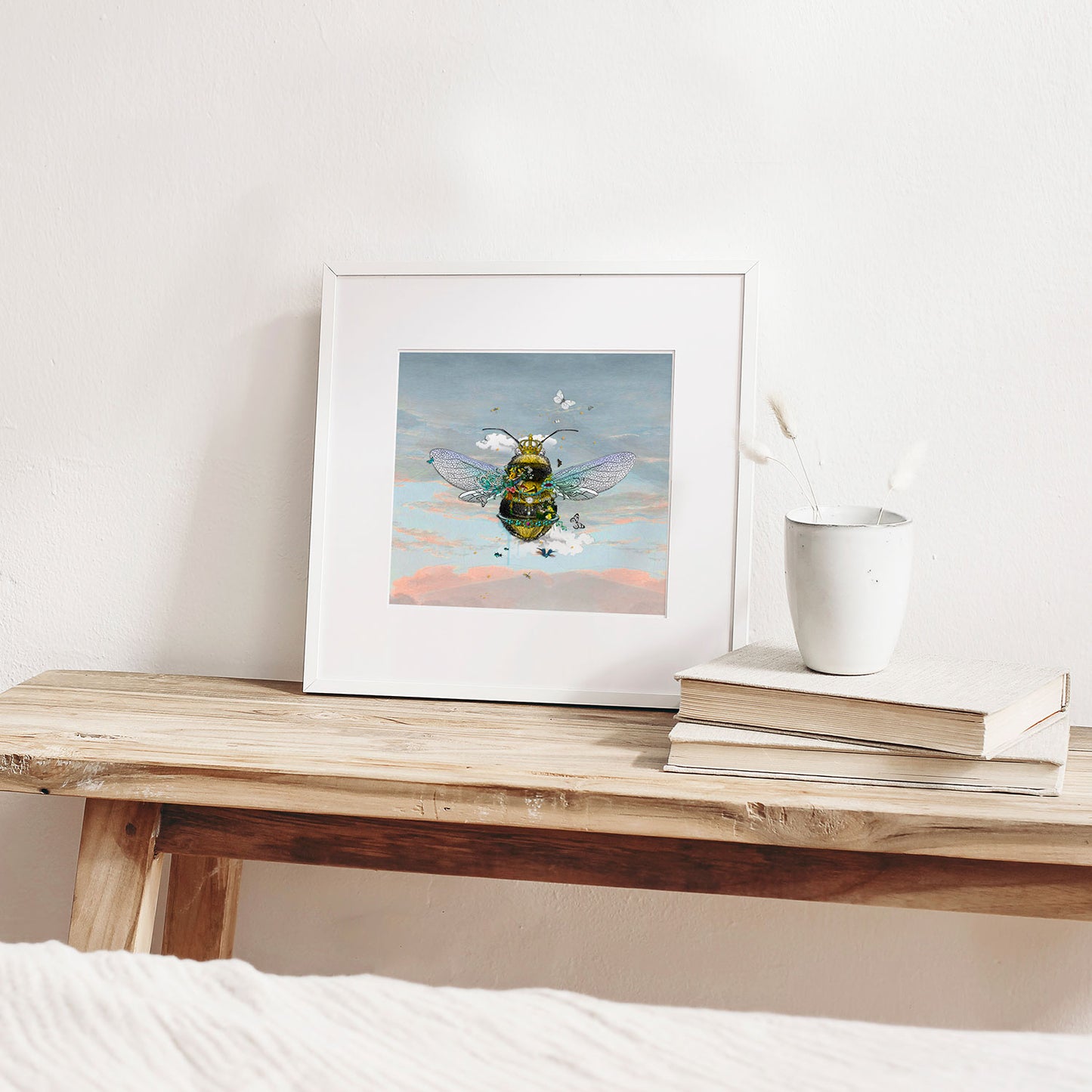 cool sky queen bee limited edition print yellow and black bumble bee wearing a crown surrounded by butterflies dragonflies birds and flowers on a blue peach sunset calm sky by artist kristjana williams 